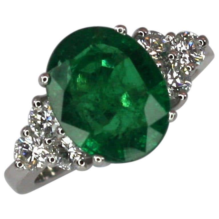 18 Karat White Gold Oval Natural Emerald and Diamond Ring